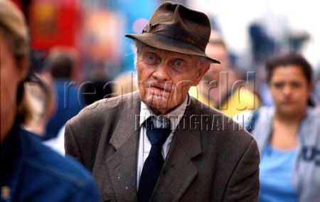 A lonely old man walks the streets of Central London, England. Gary Moore photo.